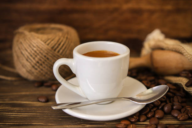 istock coffee espresso isolated on wooden table 1004928906
