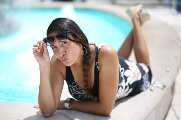 istock Young lady relaxing by pool of water 1004939146