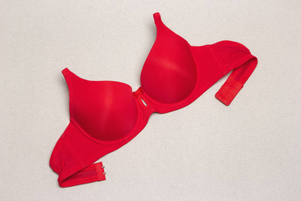 istock Strapless push up graceful neckline red bra on grey background 1004949126
