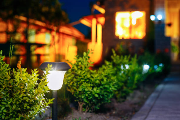 istock Small Solar Garden Light, Lantern In Flower Bed. Garden Design. Solar Powered Lamp 1004952194