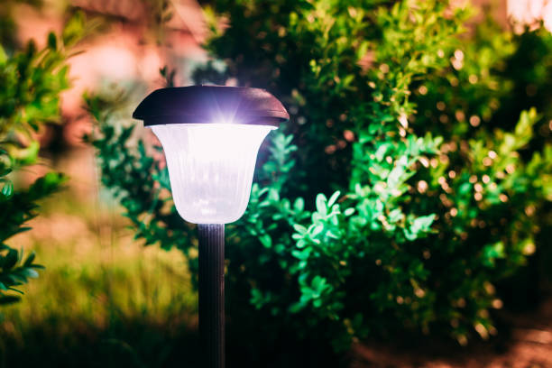 istock Close View Of Limelighted Energy-Saving Solar Powered Lantern Glowing White Light In The Garden. 1004952256