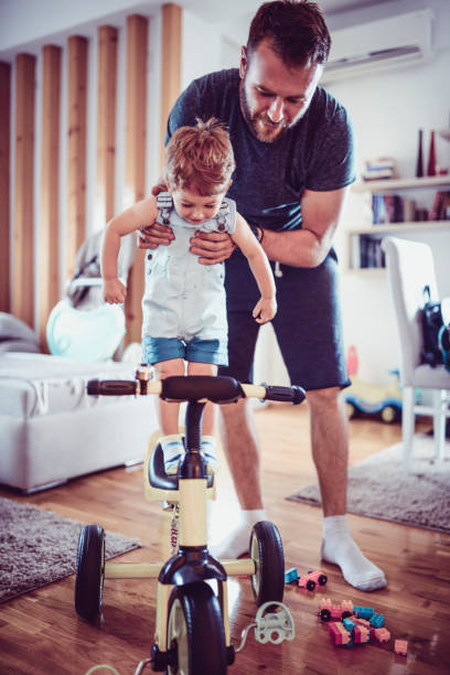 istock Father Teaching Baby Son How To Ride A Tricycle 1004968252