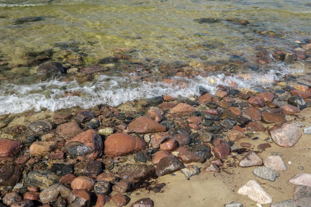 istock rocky sea beach with waves and sunny day 1004981596
