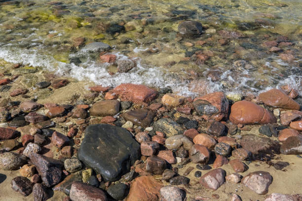istock rocky sea beach with waves and sunny day 1004981604