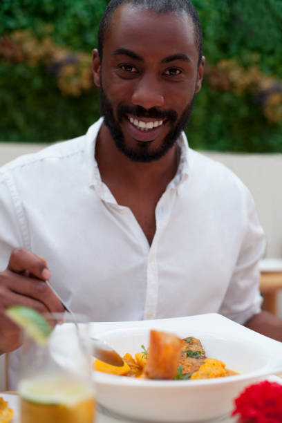 istock happy black man having lunch looking at the plate 1004986956