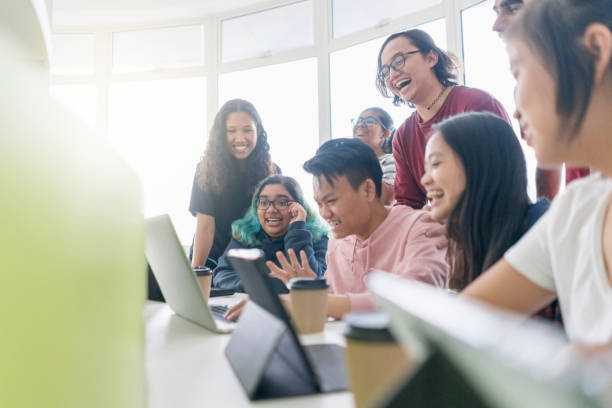 istock Group of happy young students looking something 1005011046