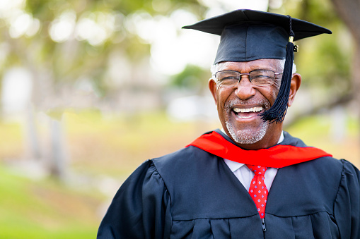 A senior black man graduates with his master's degree