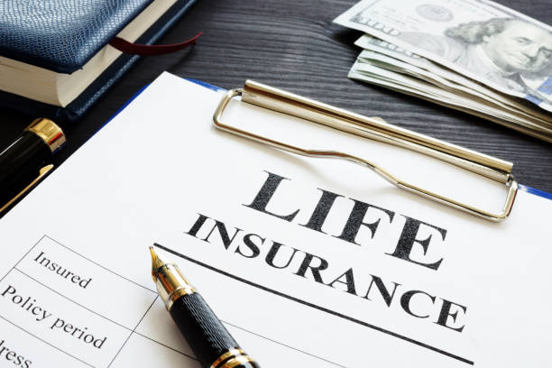 istock Whole life insurance pen and dollar banknotes. 1005014082