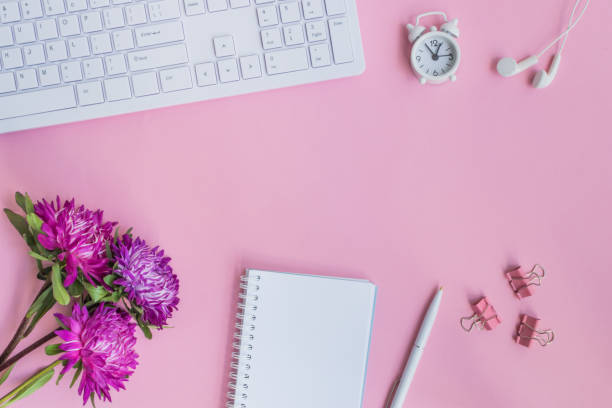 istock Blogger or freelancer workspace with notebook and pink flowers 1005014166