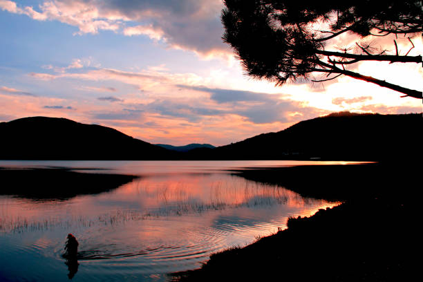 istock fisherman in the lake 1005017018