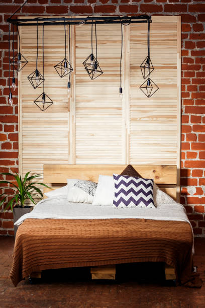istock Simple bedroom with double bed, red brick wall and big window 1005028872