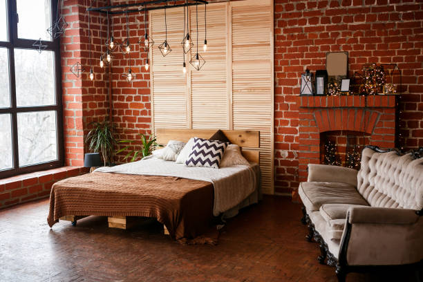 istock Simple bedroom with double bed, red brick wall and big window 1005033138