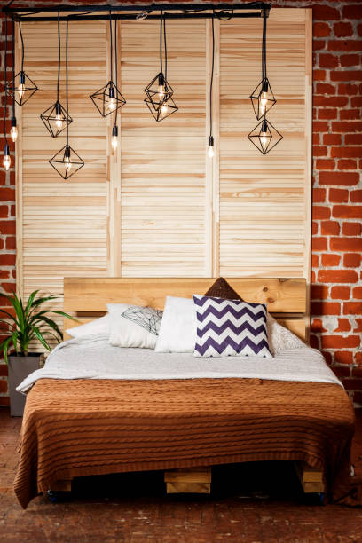 istock Simple bedroom with double bed, red brick wall and big window 1005033188