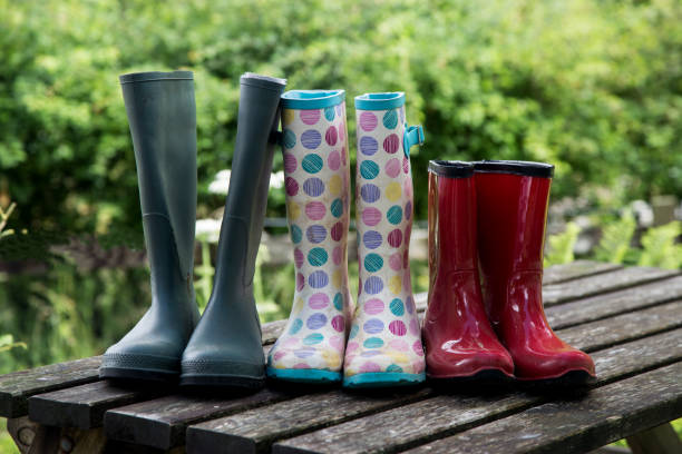 istock Muddy Waterproof Boots on a Timber Picnic Table 1005036428