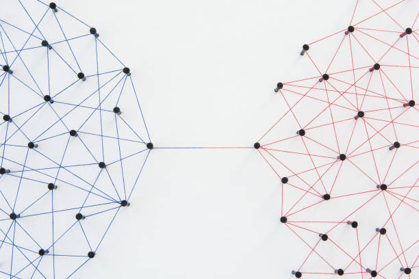 istock Connecting networks concept - two network connected with yarn red and blue on white paper. Simulator connection social media, internet, people communication 1005048188