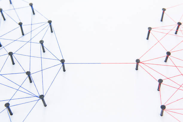 istock Connecting networks concept - two network connected with yarn red and blue on white paper. Simulator connection social media, internet, people communication 1005048472