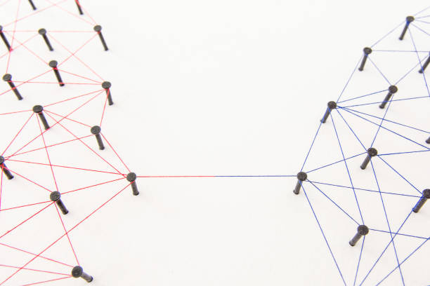 istock Connecting networks concept - two network connected with yarn red and blue on white paper. Simulator connection social media, internet, people communication 1005048484
