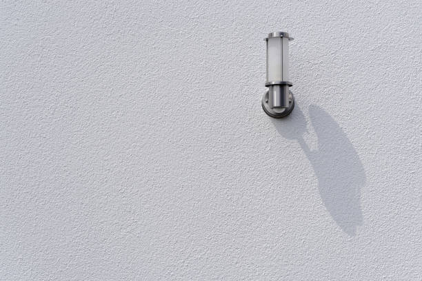istock White silver outdoor lamp on white house wall 1005048614