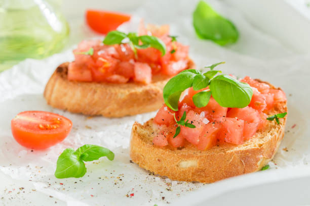 istock Fresh and tasty bruschetta with basil and tomato 1005053432