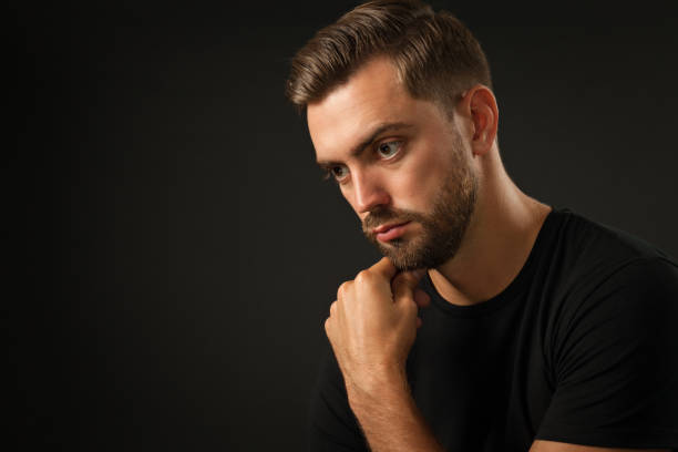 istock studio portrait of a 30 year old man with a beard in the studio on a black background 1005072798