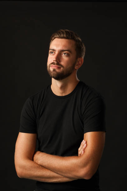 istock studio portrait of a 30 year old man with a beard in the studio on a black background 1005073198