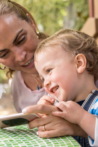 istock Mature woman playing with her toddler 1005073400