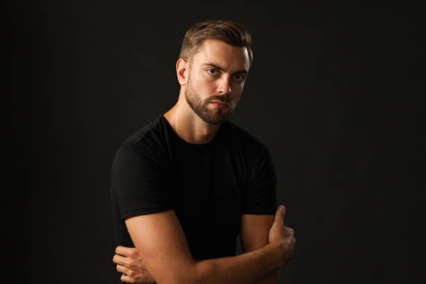 istock studio portrait of a 30 year old man with a beard in the studio on a black background 1005073656