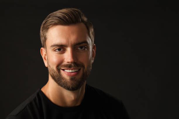 istock studio portrait of a 30 year old man with a beard in the studio on a black background 1005080584