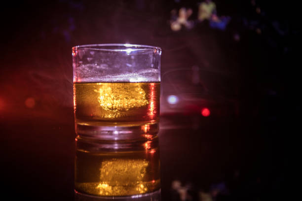 istock selective focus pure whisky with ice cube inside whisky glass on dark foggy background alcohol drink concept. 1005086020