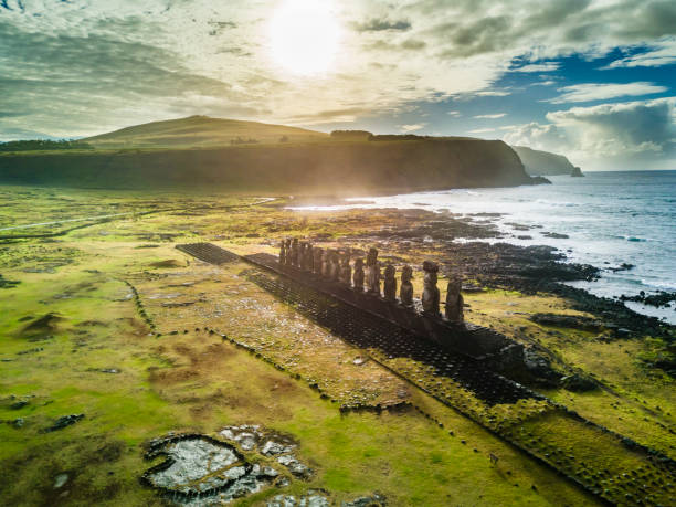 an aerial view over ahu tongariki, the most amazing ahu platform on easter island. 15 moais still stand up at the south east of the island. ahu tongariki reveals the moais magic. - moai statue imagens e fotografias de stock