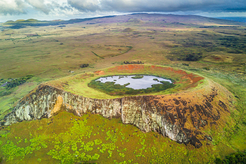 An aerial view over Rano Raraku Volcano, the Moais quarry where all were built on the past, some of them still stay on the quarry waiting to, maybe, one day reach there final destination