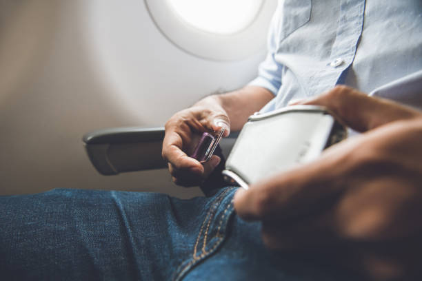 istock Passenger fastening seat belt while sitting on the airplane 1005124722