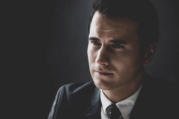 istock Man in shadow with serious face staring at interlocutor 1005124758