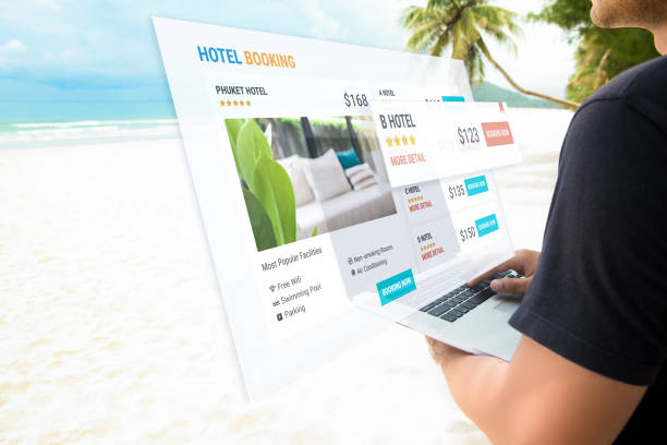 istock Casual man using laptop computer at the beach booking hotel online 1005124760