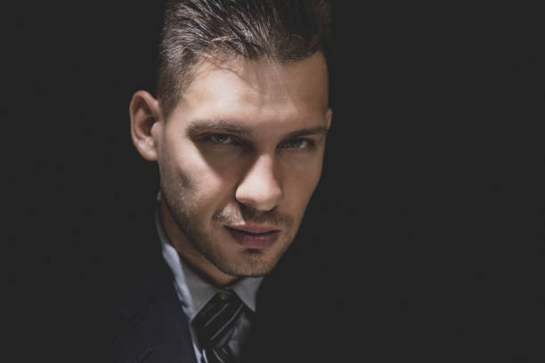 istock Cunning sly man face in dark room 1005124864