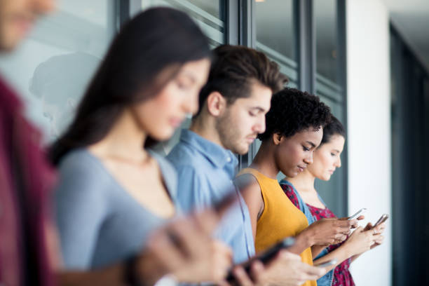 istock Young people holding and using their mobile phones 1005127246