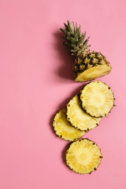 istock Ripe pineapple on pastel pink background 1005145352