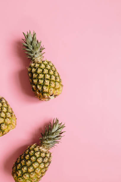 istock Ripe pineapple on pastel pink background 1005145362