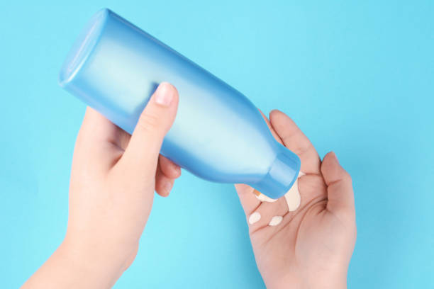 istock Close up view of hans holding empty sunscreen 1005148352