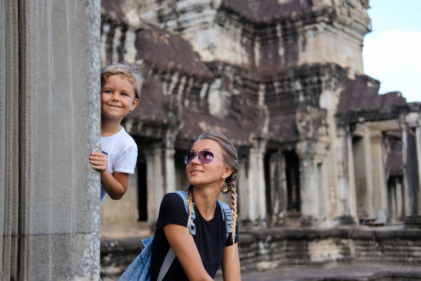 Happy smiling mother and son together visiting Angkor, Cambodia