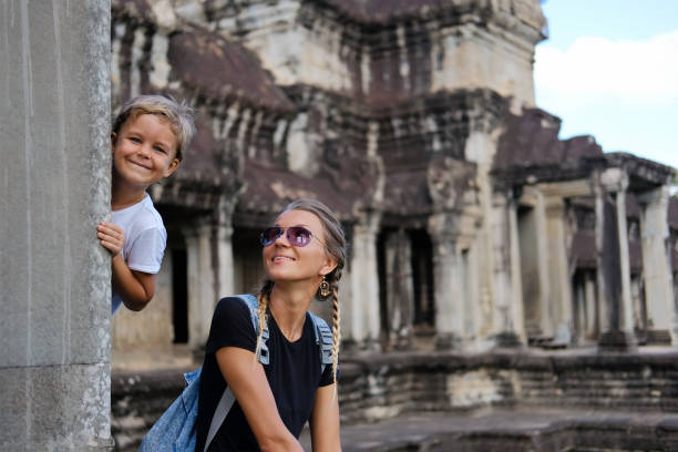 Happy smiling mother and son together visiting Angkor, Cambodia