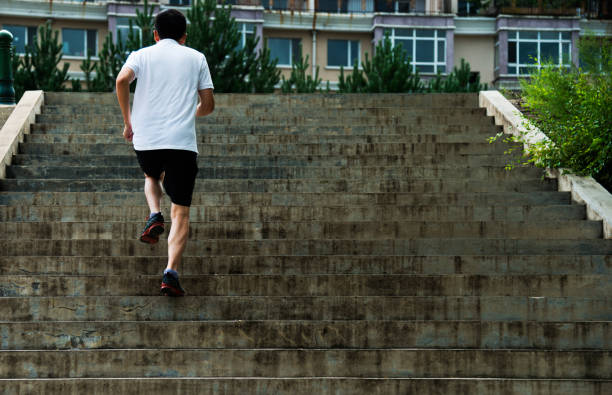istock Man running up outdoor stairs 1005177024
