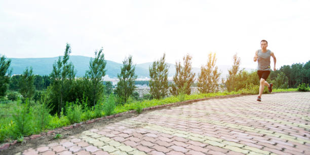 Man running on brick road of park