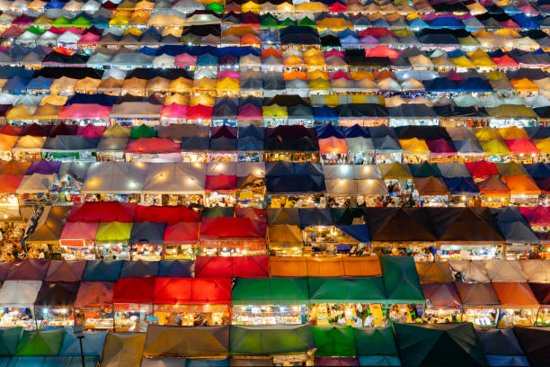 istock Aerial view multiple colour roof top flea market night view 1005193688