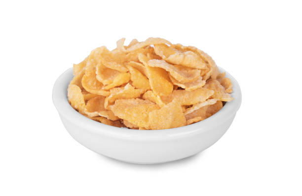 istock Breakfast cereal cornflakes in white ceramic bowl isolated on white background 1005206660