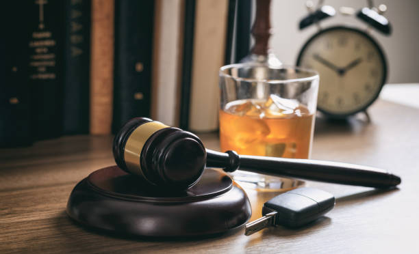 Law gavel, alcohol and car keys DUI concept. Law gavel, alcohol and car keys on a wooden desk, dark background pics of drunk driving accidents stock pictures, royalty-free photos & images