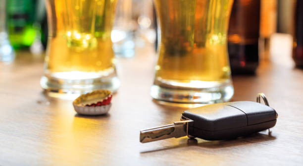 Drinking and driving concept Drinking and driving concept. Car key on a wooden table, pub background pics of drunk driving accidents stock pictures, royalty-free photos & images