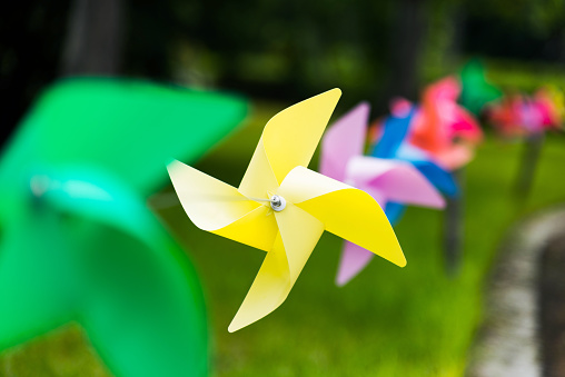 Origami wind turbines hunging in a row