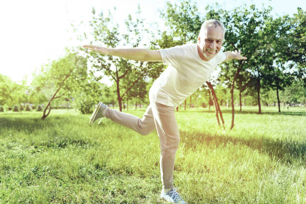 istock Cheerful aged man enjoying funny exercises 1005234746