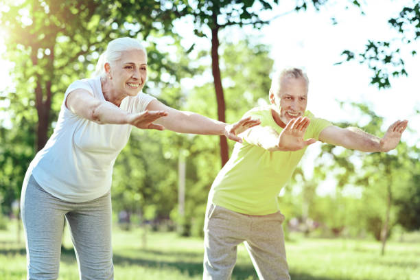 istock Adorable pensioners bending and stretching at their training 1005235020